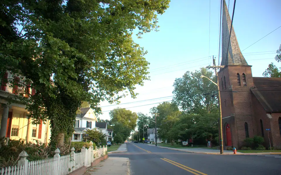 Tree-lined Sixth Street and St. Philip's church in Laurel's historic district